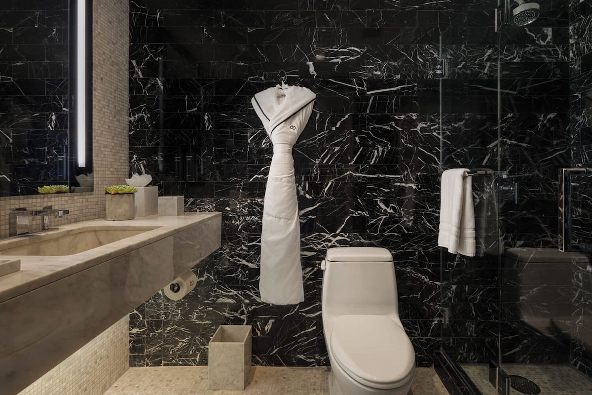 Designer toiletries, hair dryer, slippers, towels