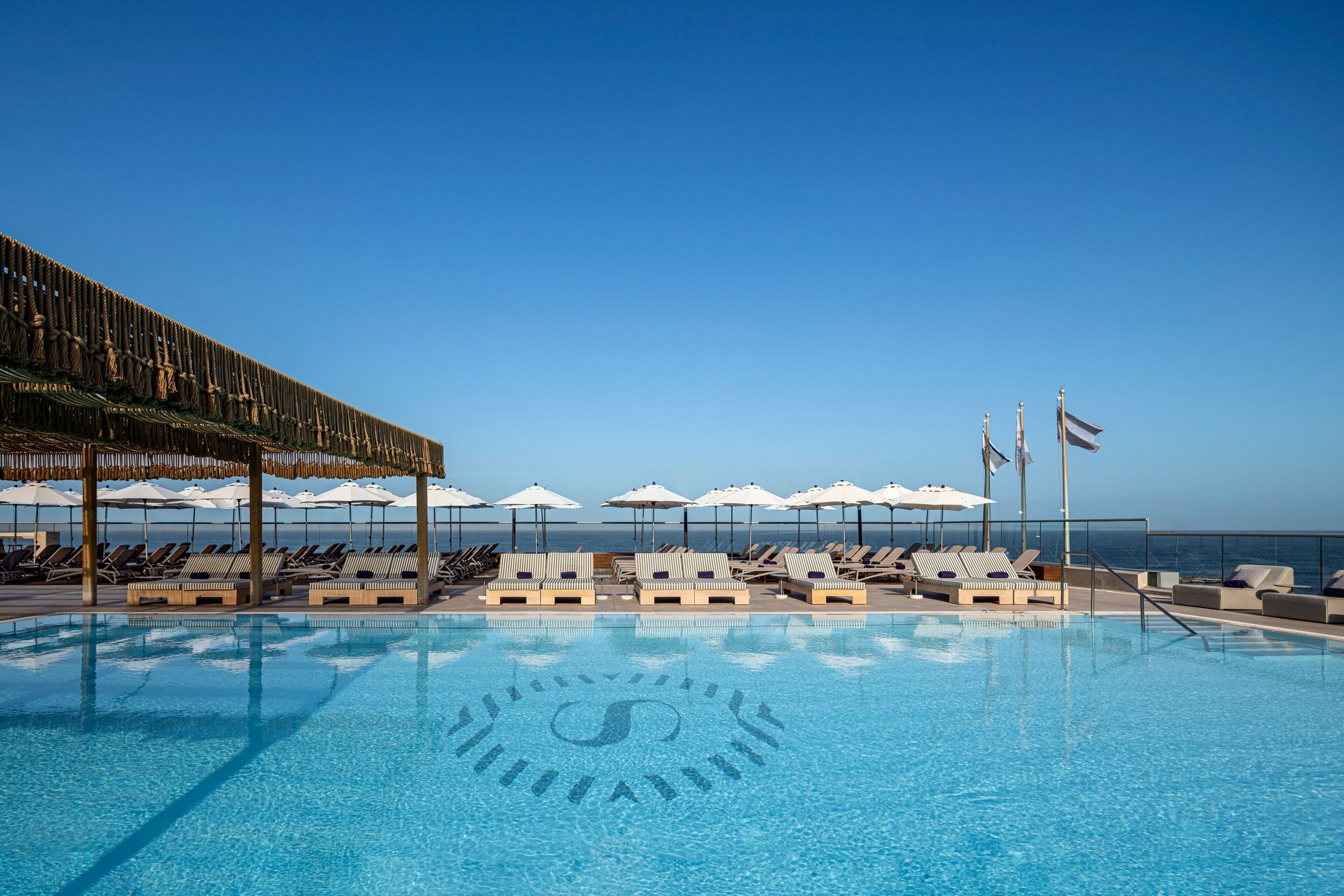 outdoor pool, open 9:00 am to 7:00 pm, pool umbrellas, pool loungers