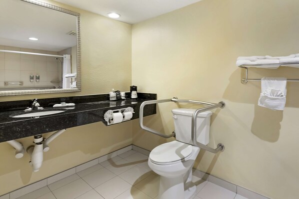 A modern bathroom with a sink, toilet, and mirror. - Best Western McAllen Medical Center (McAllen)