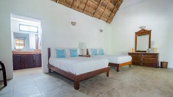 Un dormitorio con dos camas, un aparador de madera, un espejo y una ventana con vistas al exterior.