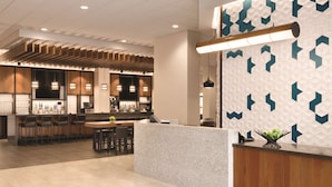 Un moderno bar con mostrador, asientos y una pared con diseño.