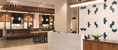A modern bar area with a counter, seating, and a patterned wall.
