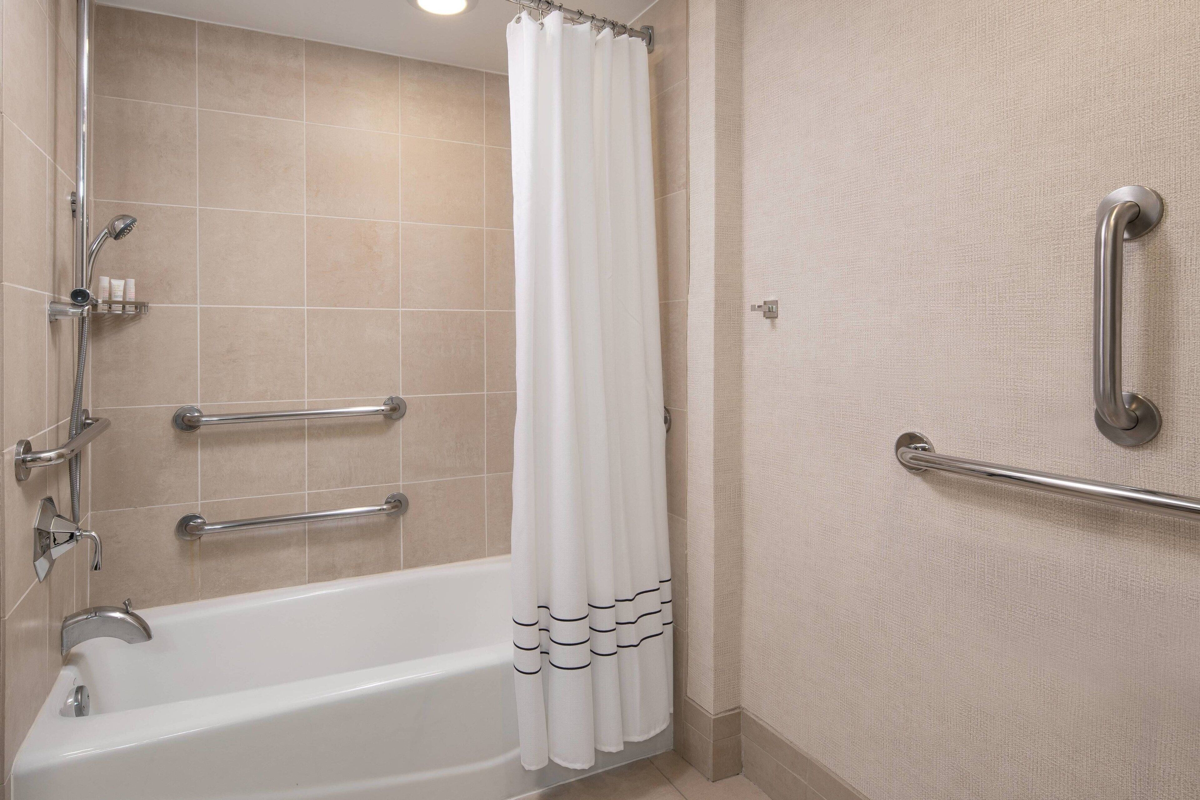 combined shower/bathtub, designer toiletries, hair dryer, bathrobes