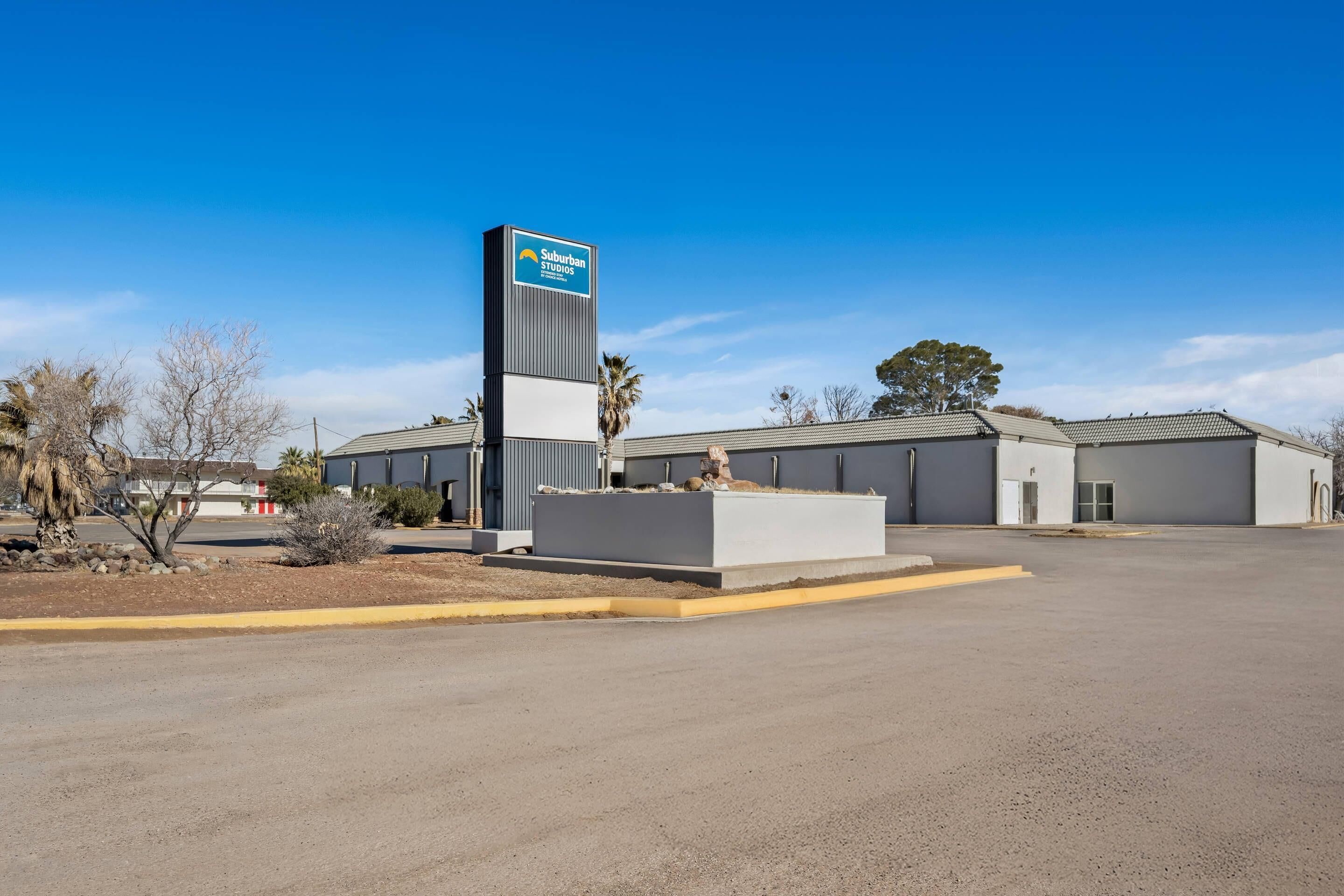 A commercial building with a prominent sign reading "Suburban Studios."