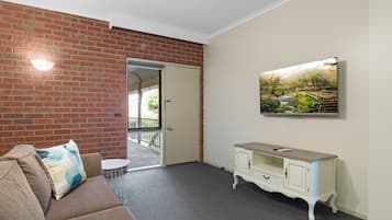 1 Bedroom Apartment | Living area | 50-inch Smart TV with digital channels, TV