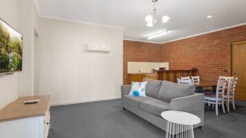 1 Bedroom Apartment | Living area | 50-inch Smart TV with digital channels, TV