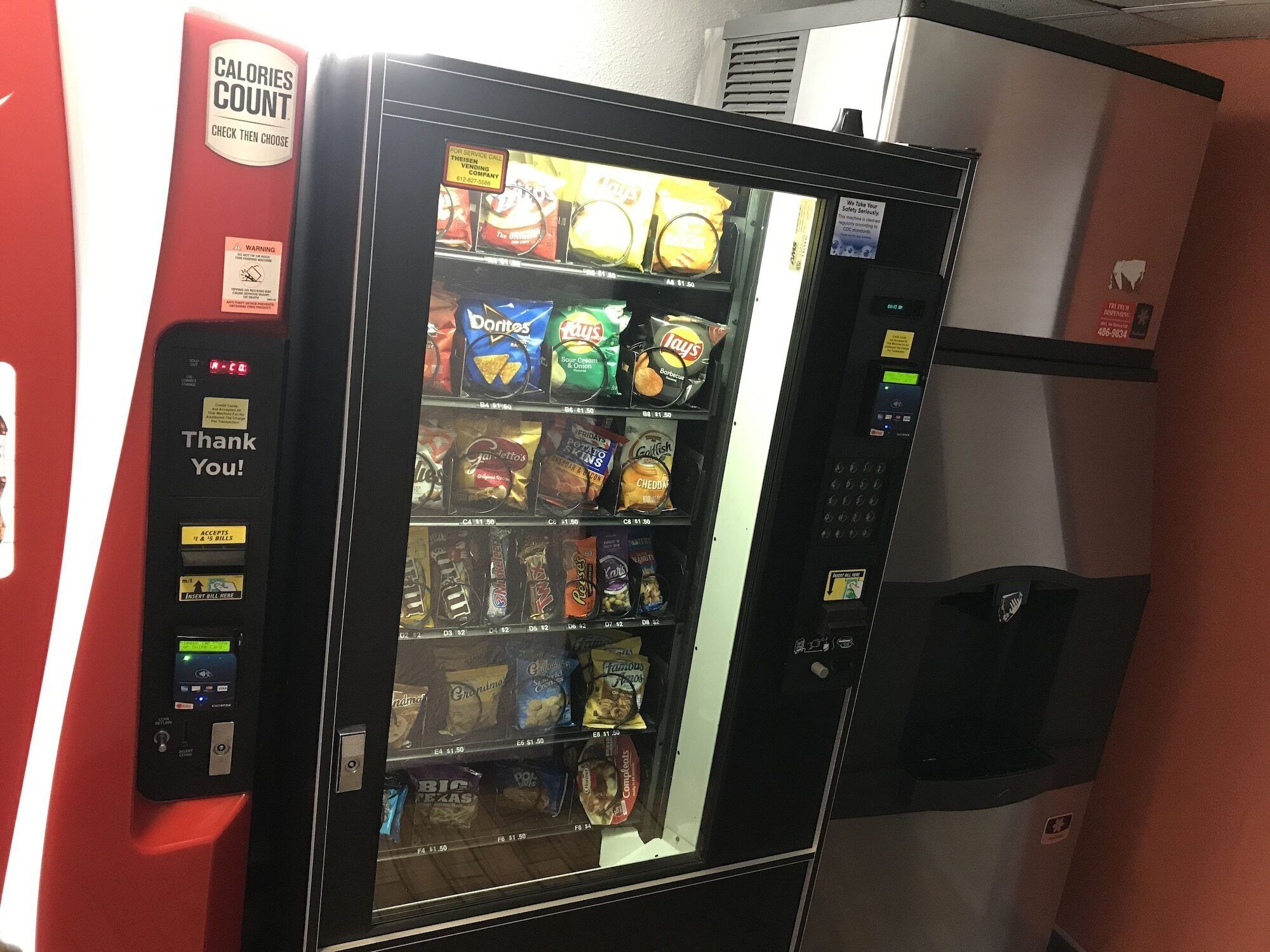 A vending machine with snacks like Doritos, Lay's, and potato chips.