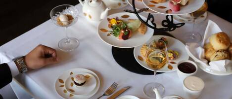 A table set for a meal with plates, glasses, and a teapot.