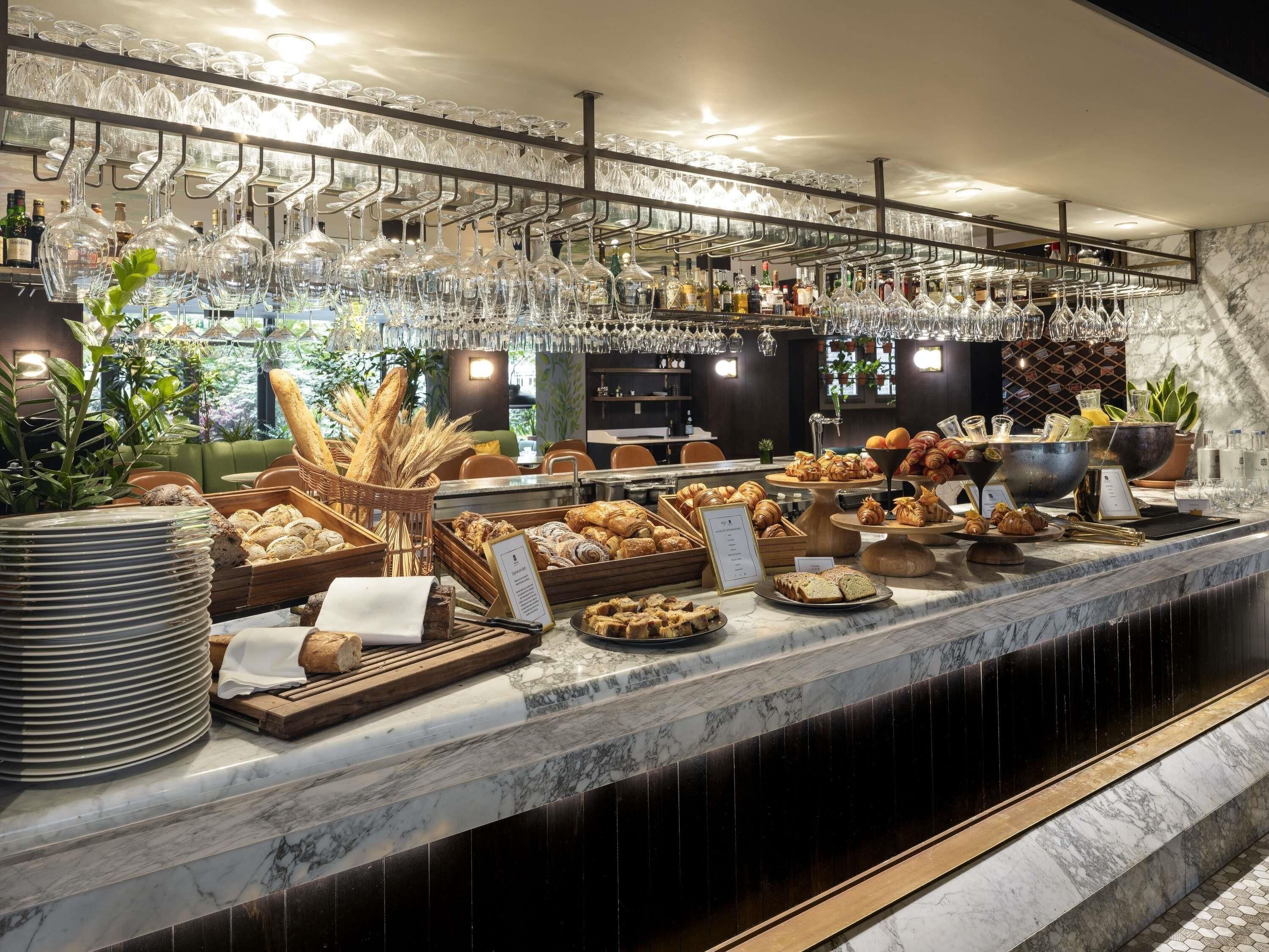 A buffet area with various food items and a wine glass rack.