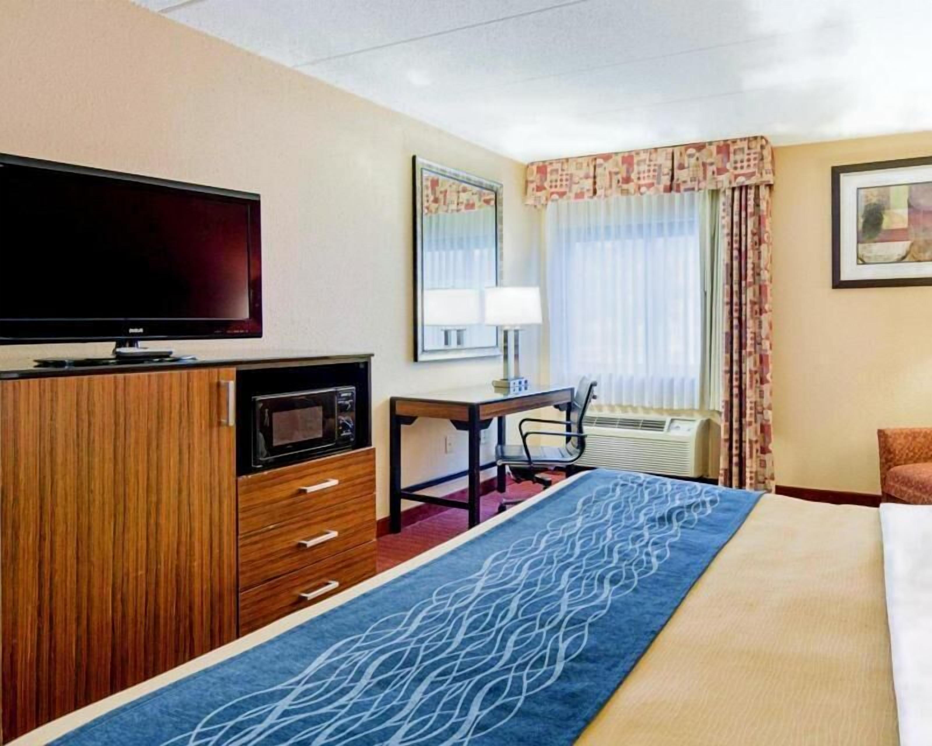 Desk, laptop workspace, blackout drapes, iron/ironing board