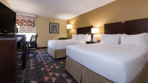 A hotel room with two beds, a desk, a chair, and a television. - Holiday Inn Lumberton by IHG (Lumberton)