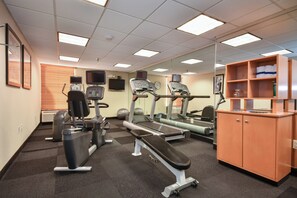 A gym with treadmills, stationary bikes, and weight machines.