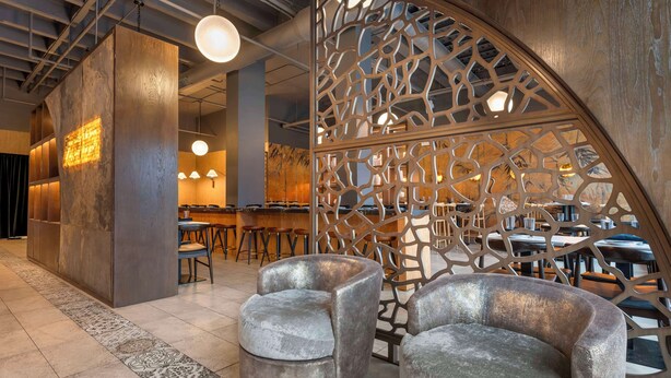 A modern interior with a bar area, seating, and decorative wooden panels. - Best Western Grant Park Hotel (Chicago)