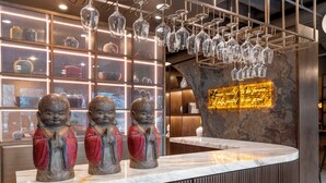 A reception area with a marble counter, decorative Buddha statues, and a wall with a quote. - Best Western Grant Park Hotel (Chicago)