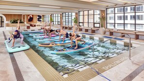 A pool area with multiple water slides and lounge chairs. - The Westin Calgary (Calgary)