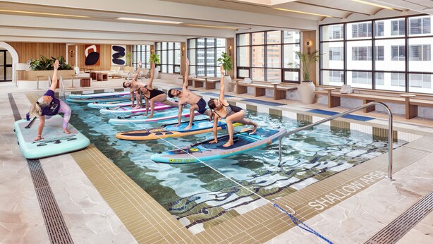 A pool area with multiple water slides and lounge chairs. - The Westin Calgary (Calgary)