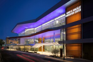 A modern building with a convention center sign, large glass windows, and a prominent staircase. - Marriott San Antonio Riverwalk (San Antonio)