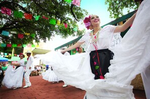 A group of people in traditional attire dancing outdoors. - Marriott San Antonio Riverwalk (San Antonio)