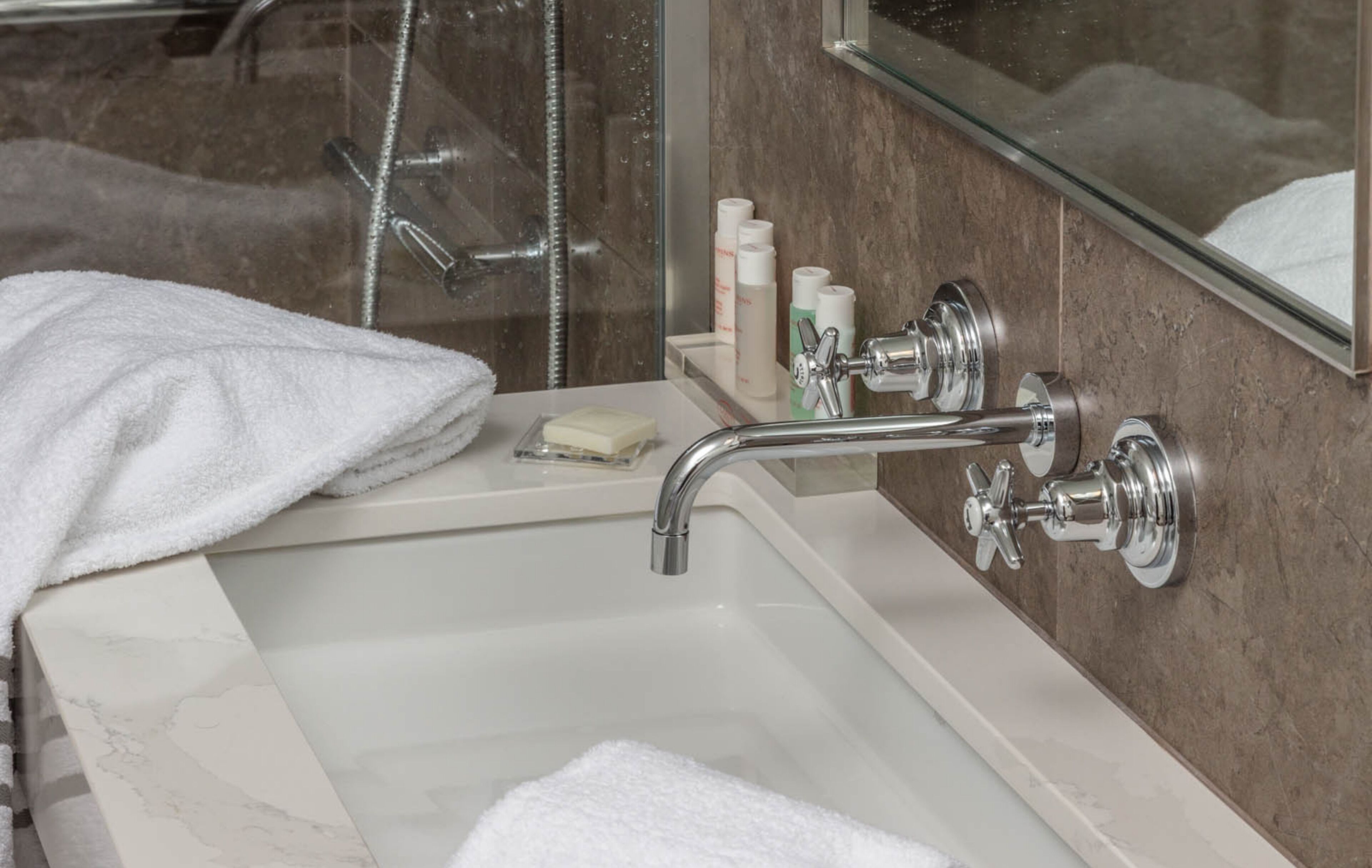 designer toiletries, hair dryer, bathrobes, slippers