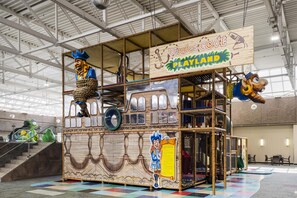 A pirate-themed play area with a ship structure, climbing nets, and a sign reading 'Pirates Cove Playland'. - Birchwood Inn, BW Premier Collection (Winnipeg)