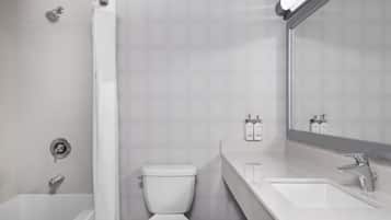 A modern bathroom with a bathtub, toilet, and sink.