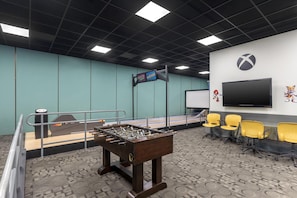 A room with a foosball table, a television, and seating area. - Hilton Vacation Club Ka'anapali Beach Maui (Kaanapali)
