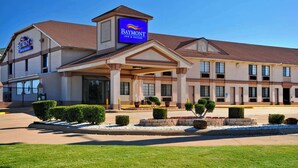 A Baymont Inn & Suites building with a prominent entrance, a covered walkway, and well-maintained landscaping. - Baymont by Wyndham Oklahoma City Airport (Oklahoma City)