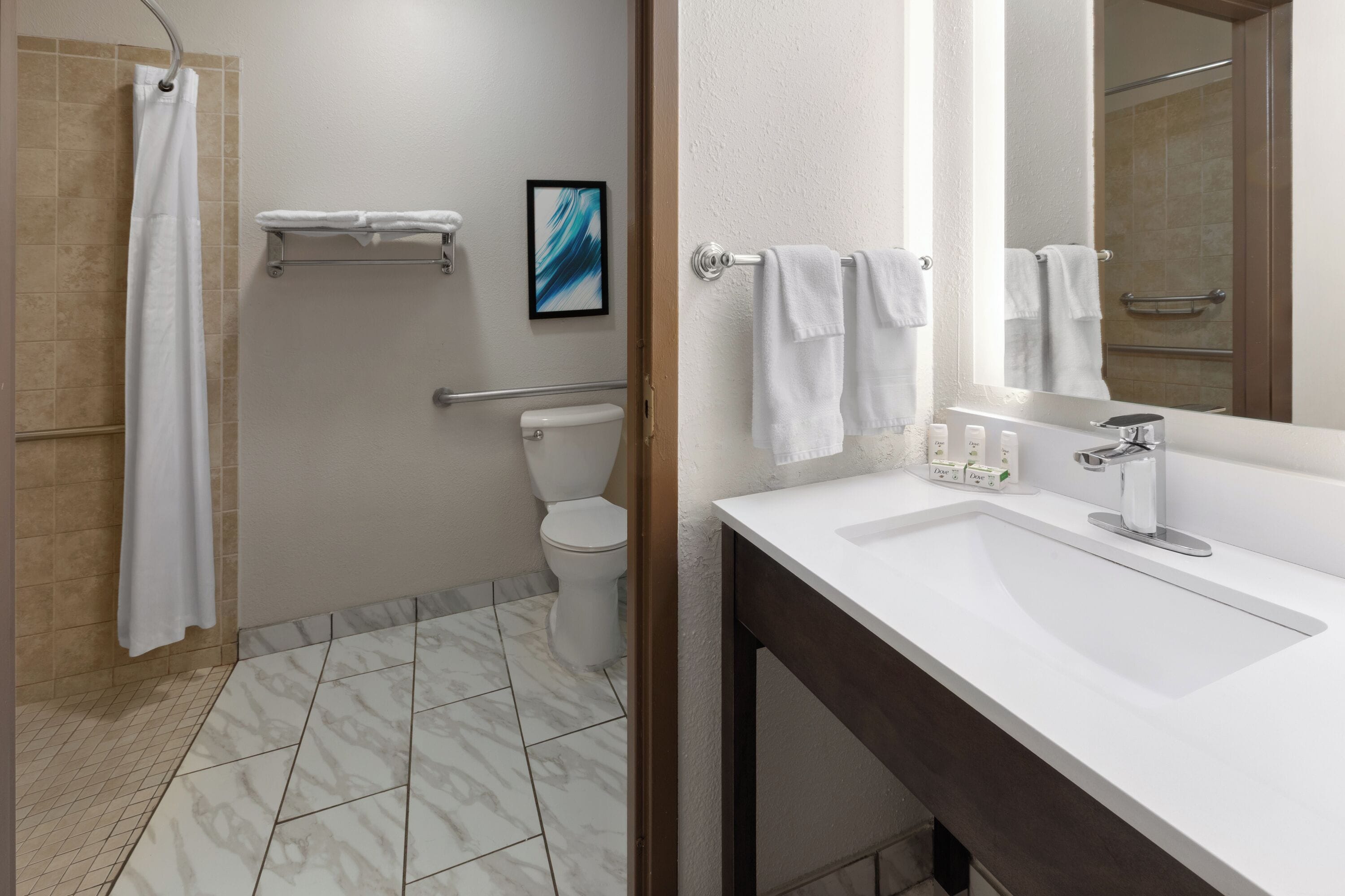 A bathroom with a shower, toilet, and sink.