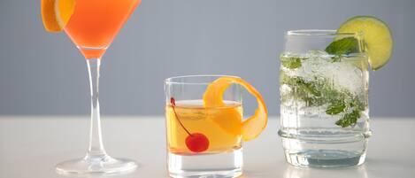 Three different types of drinks in clear glasses.