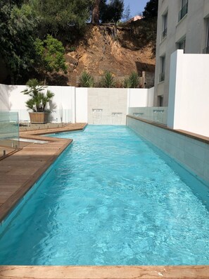 Outdoor pool, open 9:00 AM to 9:00 PM, pool loungers
