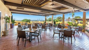 An outdoor patio area with tables and chairs, a ceiling fan, and a view of the landscape. - Westward Look Wyndham Grand Resort and Spa (Tucson)