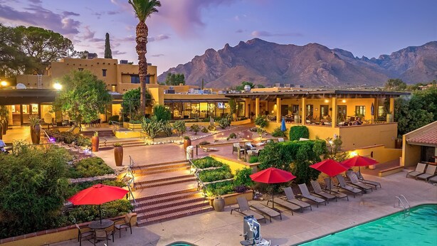 A resort with a swimming pool, outdoor seating, and mountain views. - Westward Look Wyndham Grand Resort and Spa (Tucson)