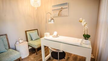 Enjoy a relaxing bathroom retreat with a glass-enclosed sink area, standing lamp, and framed beach scene.