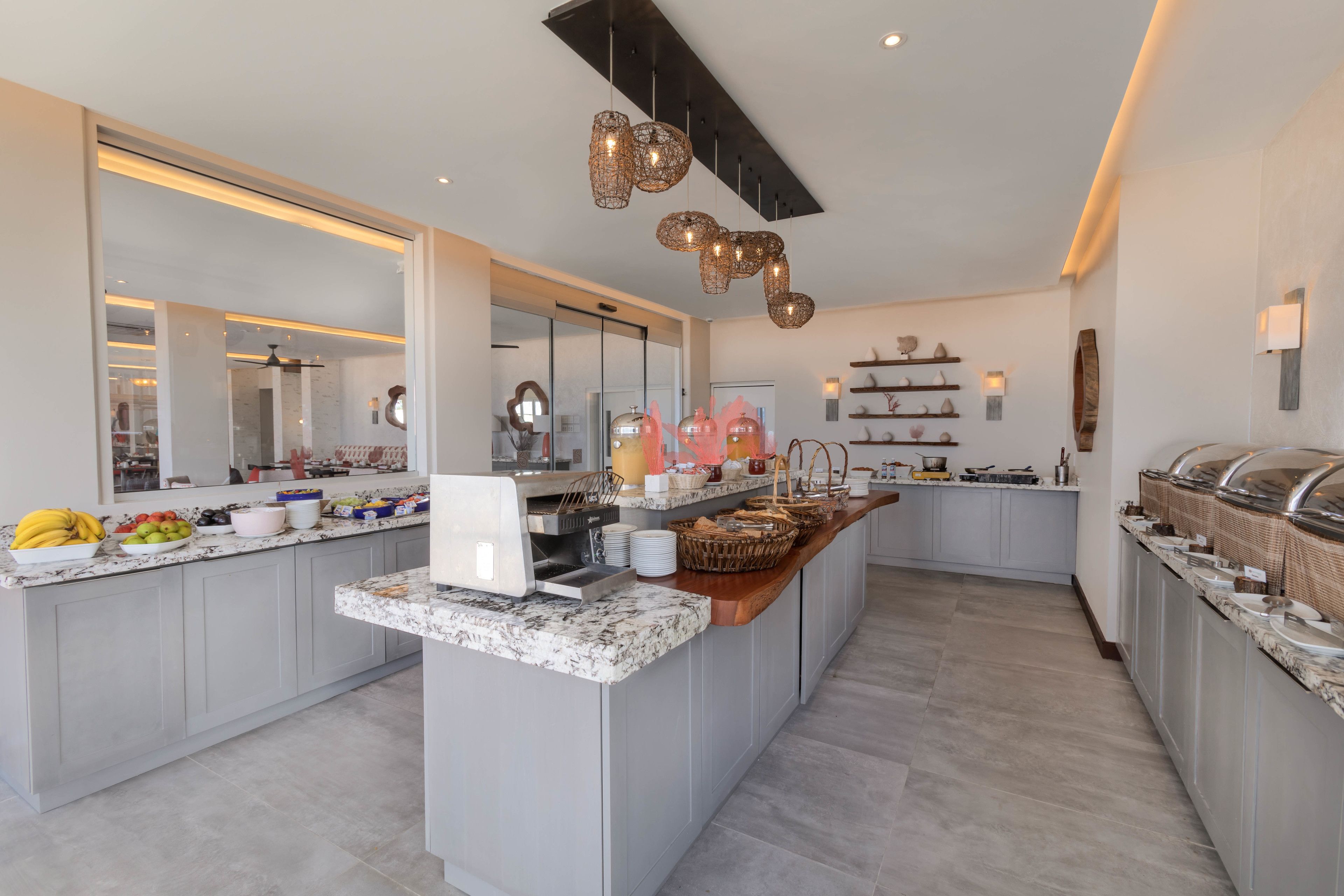 A modern kitchen with a large island, built-in appliances, and a breakfast bar.