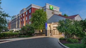 A Holiday Inn Express hotel with a brick facade, large windows, and a well-maintained lawn. - Holiday Inn Express Exton by IHG (Exton)