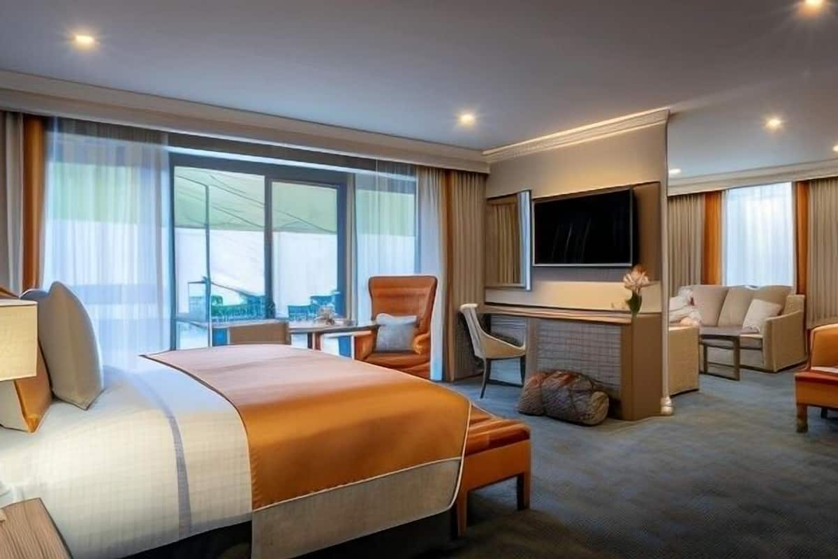 Premium bedding, desk, laptop workspace, blackout drapes