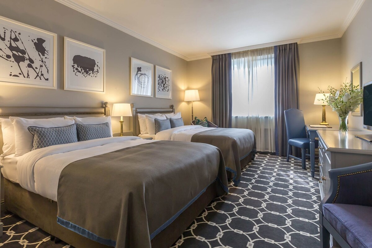 Premium bedding, desk, laptop workspace, blackout drapes