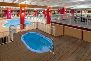 A pool area with a diving board, lounge chairs, and a deck with a railing. - Quality Inn & Suites Richfield (Richfield)