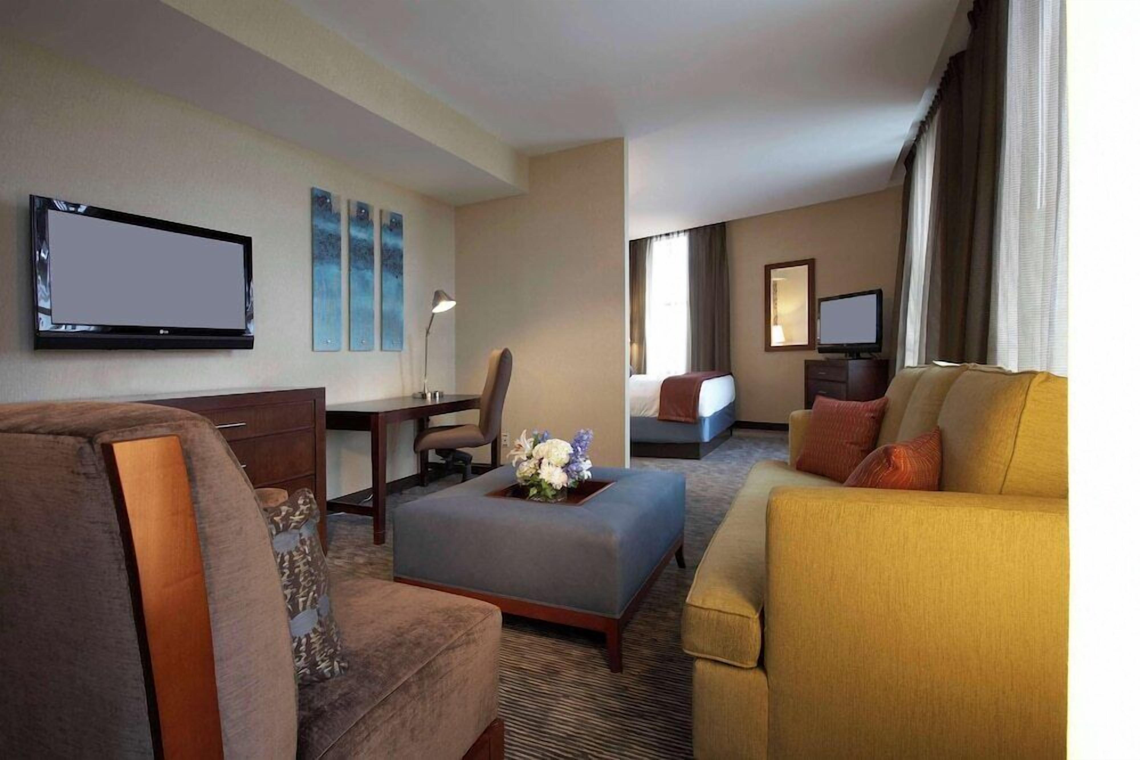 Premium bedding, desk, laptop workspace, blackout drapes