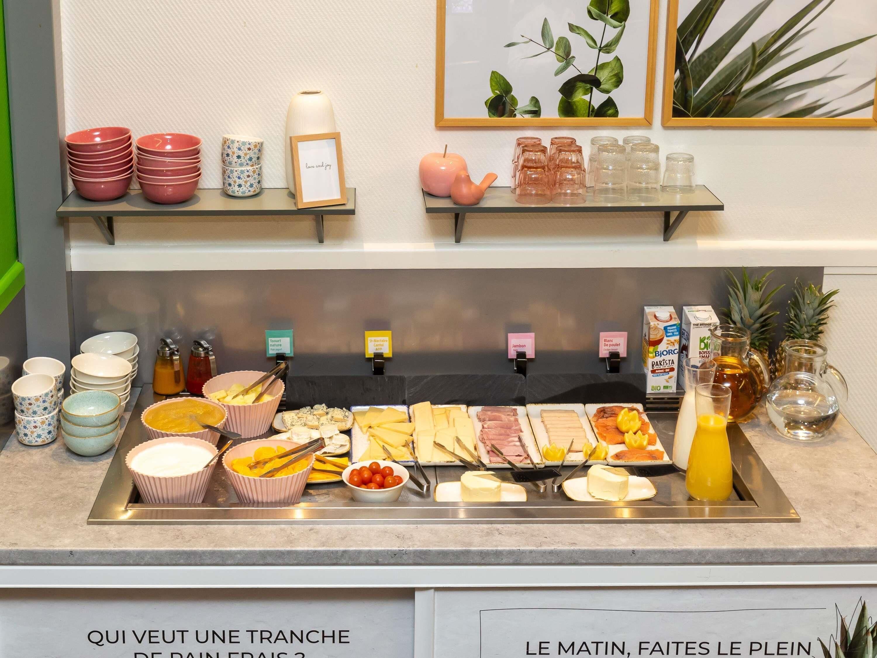 A breakfast buffet with various food items and condiments.