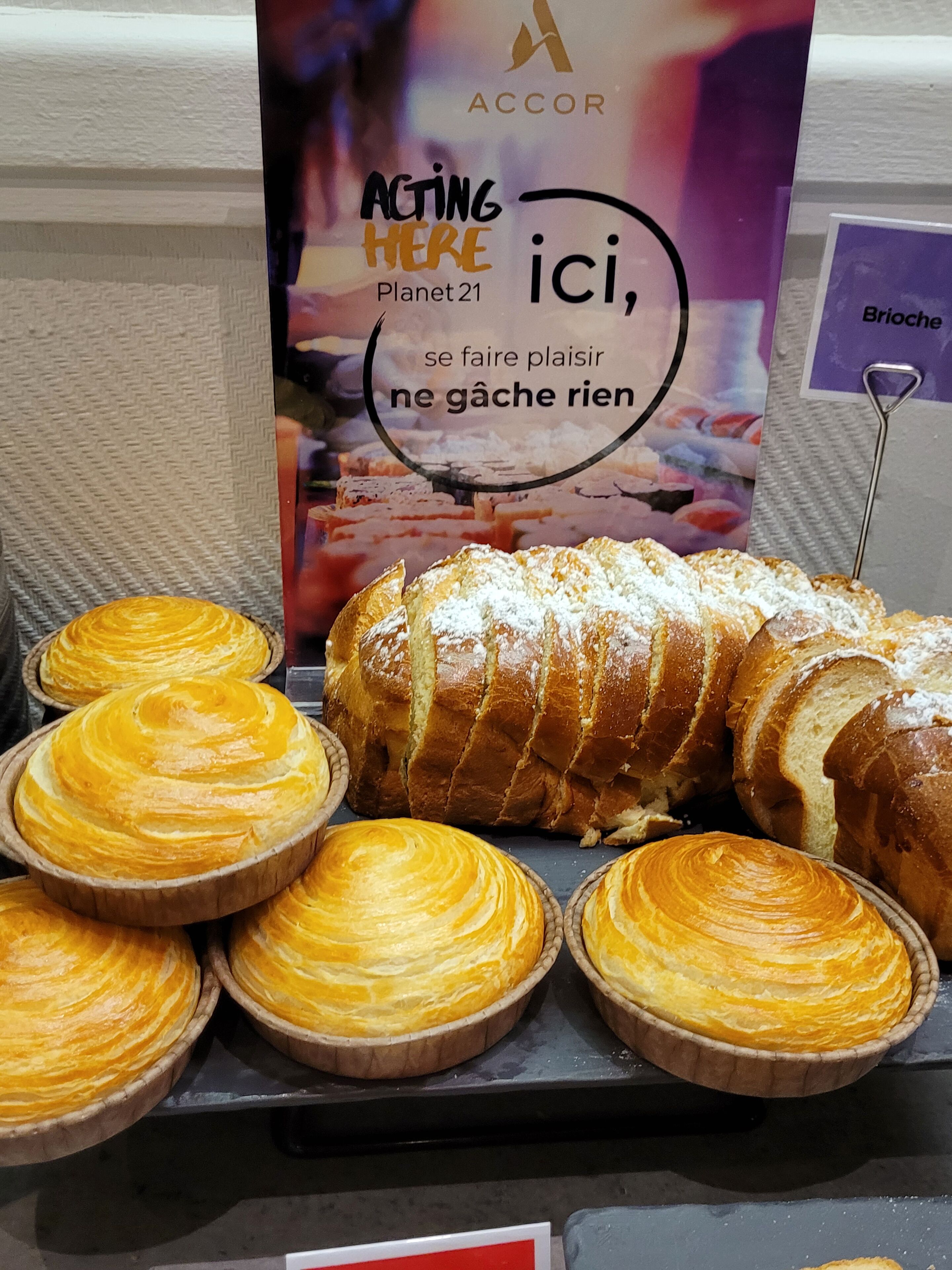 A display of pastries including a loaf of bread and several tartlets.