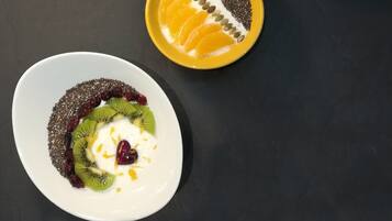Three bowls of food with different toppings on a dark surface.