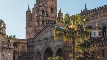 A historic building with intricate architecture, including arched walkways and a prominent tower.