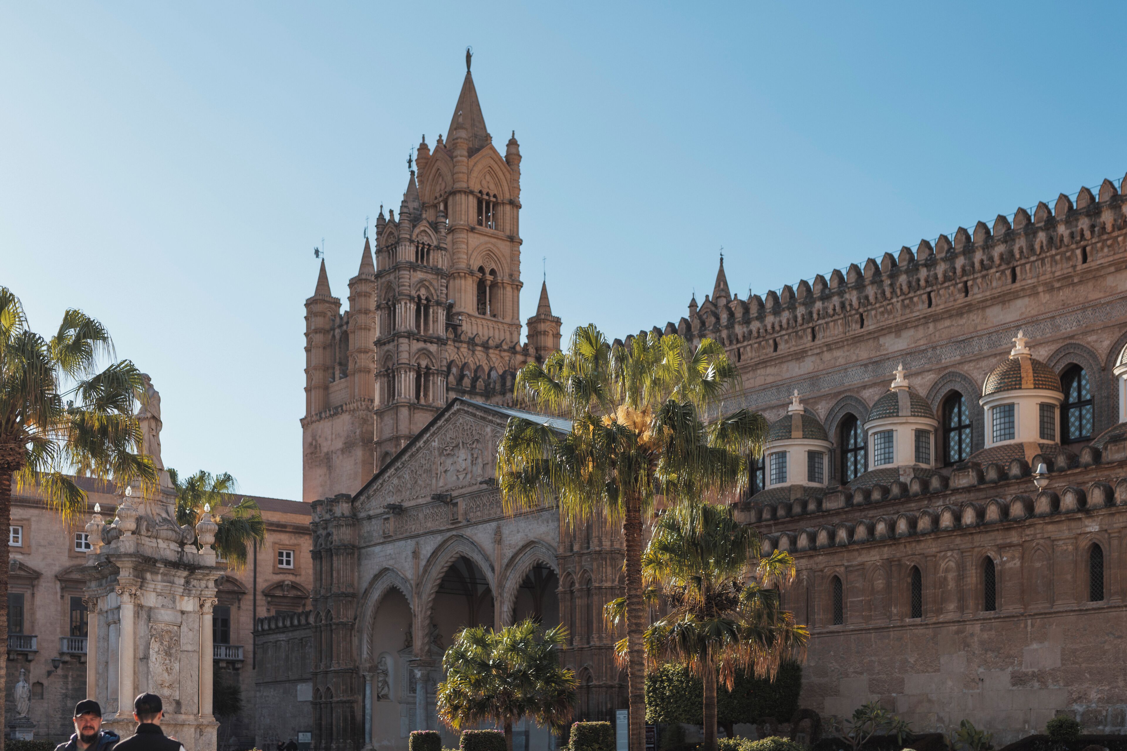 A historic building with intricate architecture, including a prominent tower and arched windows.