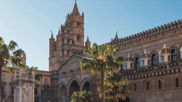 A historic building with intricate architecture, including a prominent tower and arched windows.