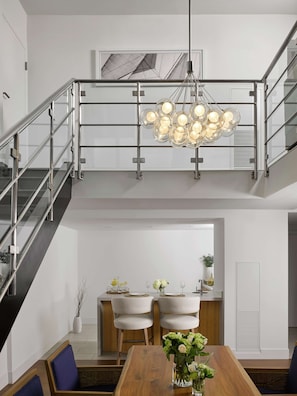 A modern interior with a staircase, dining area, and a chandelier. - Hilton Fort Lauderdale Marina (Fort Lauderdale)