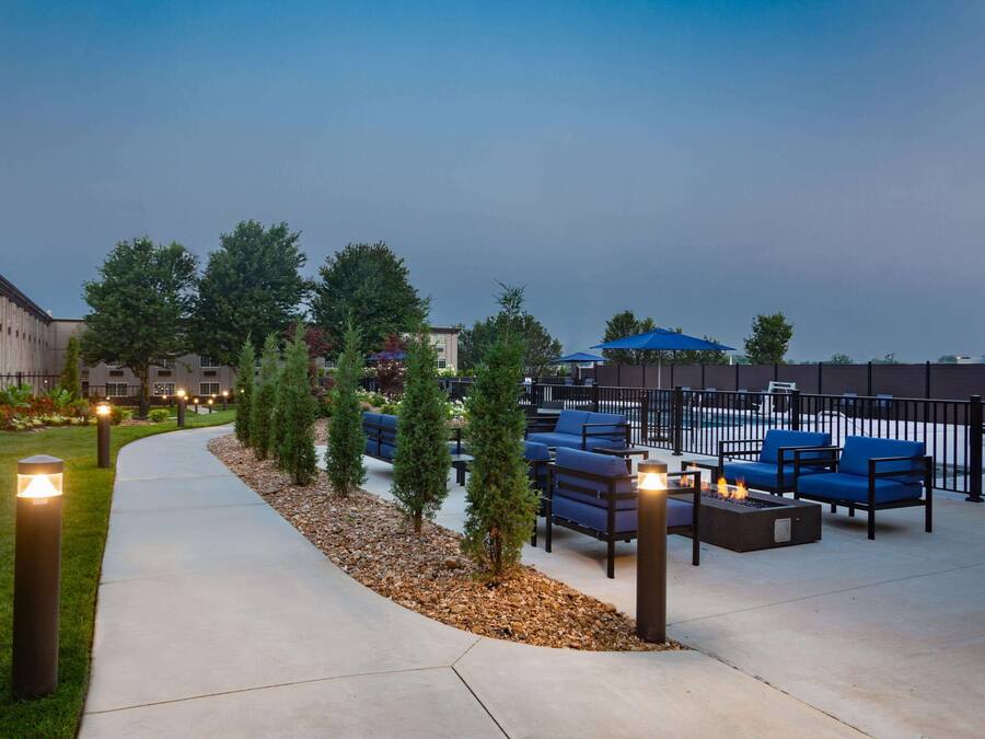 An outdoor patio area with seating and a pool.