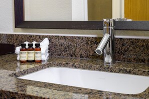 Bathroom features a granite countertop, white sink, and chrome faucet.