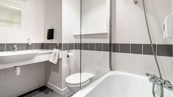 A modern bathroom with a white sink, toilet, and bathtub.