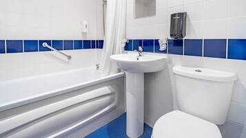 A bathroom with a bathtub, a sink, and a toilet.